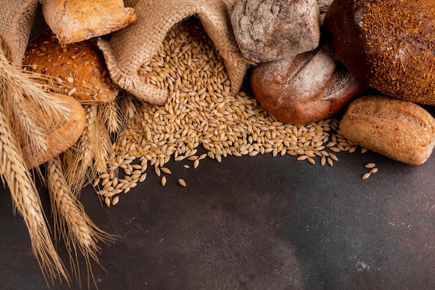 High angle of wheat seeds spilling out of jute bag