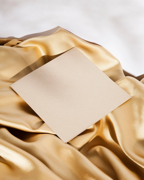 High angle white card on golden cloth