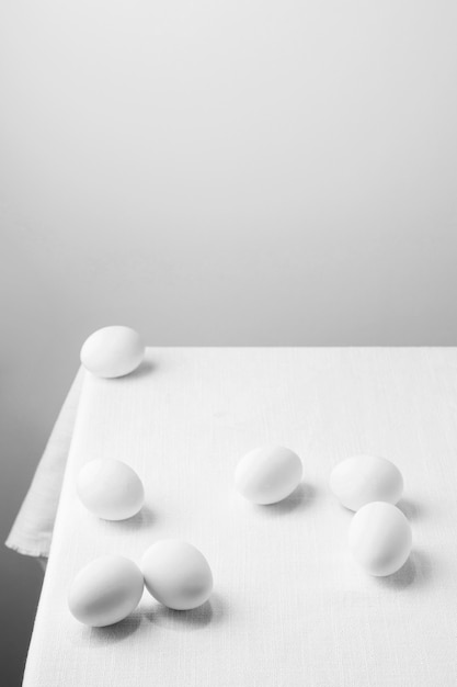 High angle white chicken eggs on table with copy-space