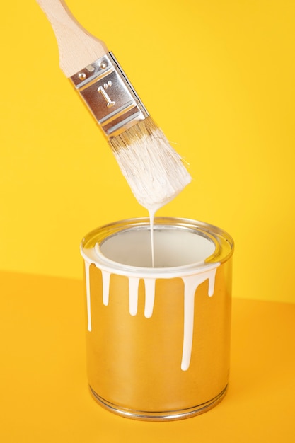 High angle white paint can with brush