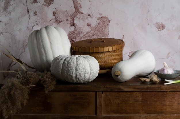 High angle white pumpkins and basket arrangement