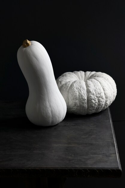 High angle white pumpkins on dark table