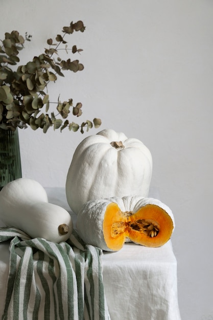 High angle white pumpkins and leaves