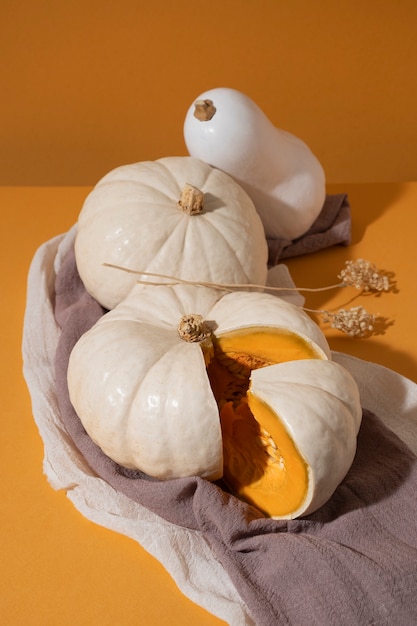 Free photo high angle white pumpkins on orange background