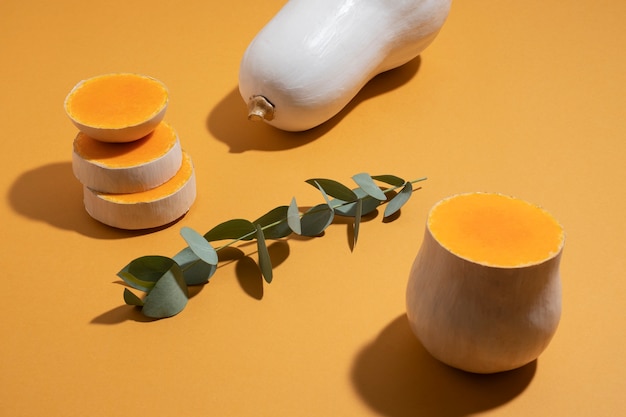 Free photo high angle white pumpkins on orange  background