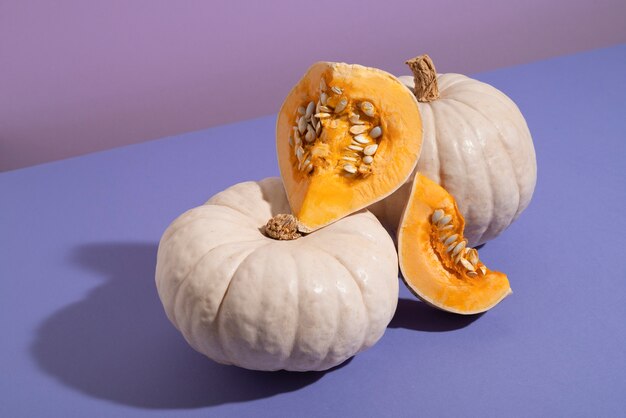 Free photo high angle white pumpkins with purple background