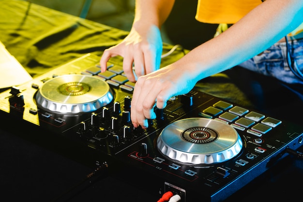 High angle woman as dj mixing and entertaining