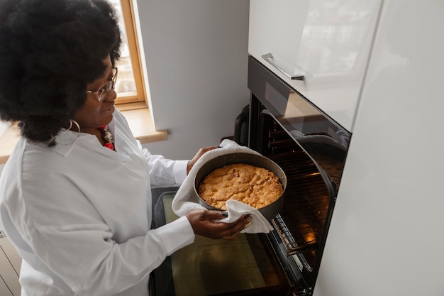 Free photo high angle woman baking at home