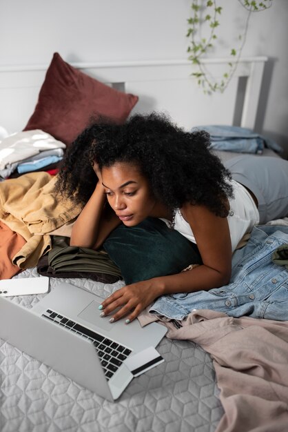 High angle woman in bed with laptop