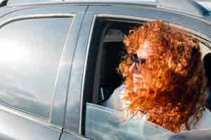 Free photo high angle woman in car