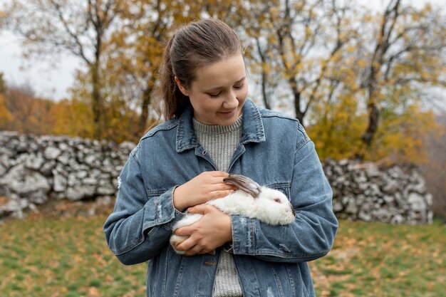 High angle woman caring rabbit