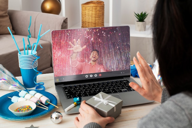 High angle woman celebrating birthday with device