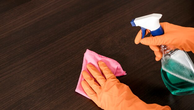 High angle of woman cleaning the table