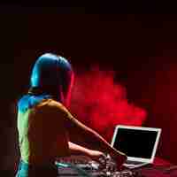 Free photo high angle woman dj mixing audio console