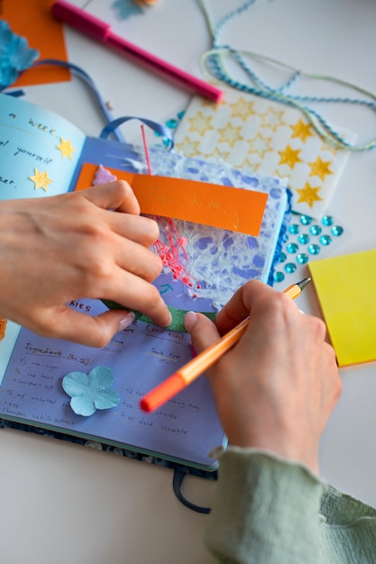 High angle woman doing creative journaling