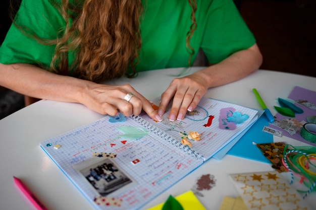 Free photo high angle woman doing creative journaling