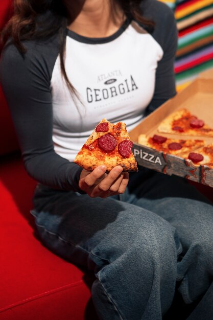 High angle woman eating pizza