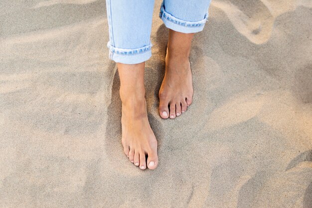 High angle of woman feet in the sand at the beach