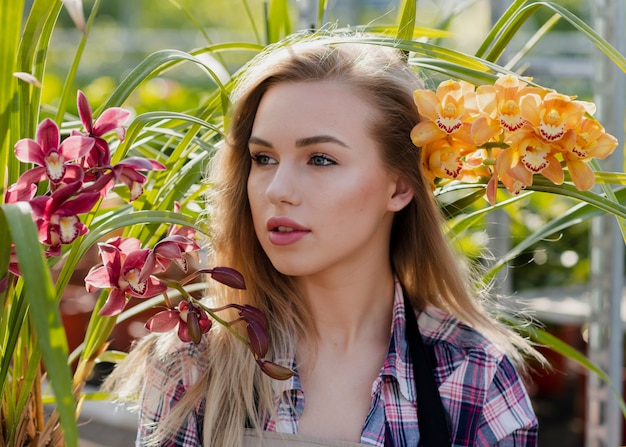 Free photo high angle woman between flowers