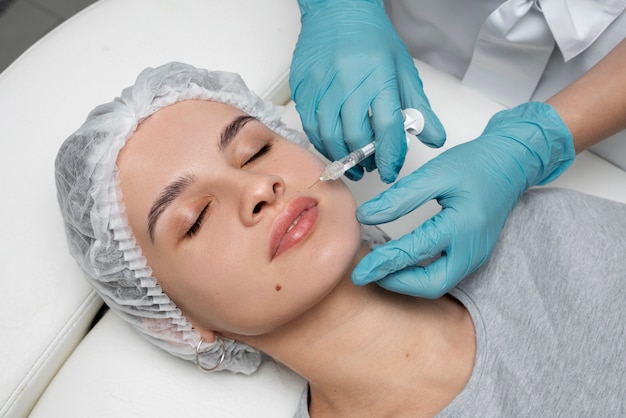 High angle woman getting injection at clinic