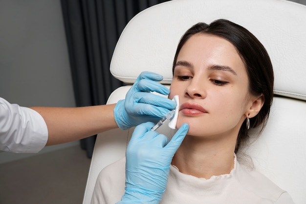 High angle woman getting lip fillers