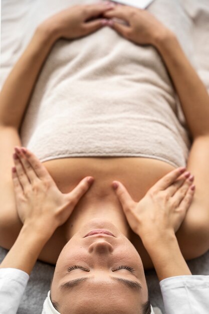 High angle woman getting massaged at spa