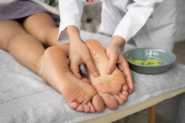 Free photo high angle woman getting massaged at spa