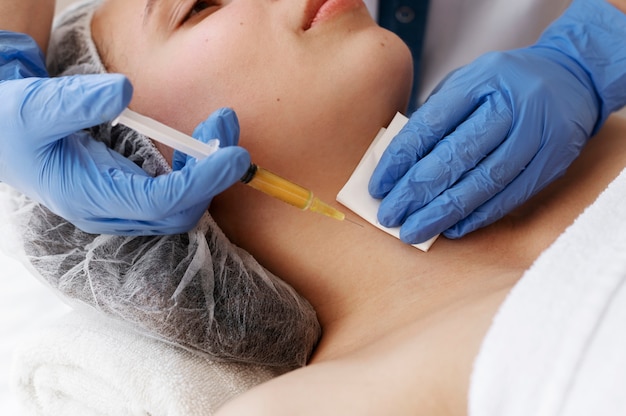 High angle woman getting neck prp treatment