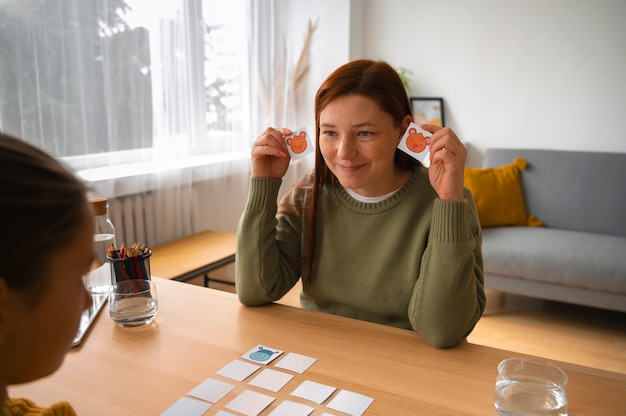 Free photo high angle woman and girl playing memory game