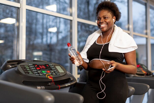 High angle woman at gym using mobile