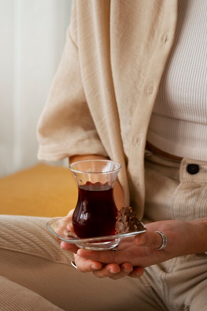 Free photo high angle woman holding delicious tea