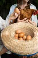 Free photo high angle woman holding eggs