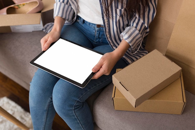 High angle woman holding an empty screen tablet