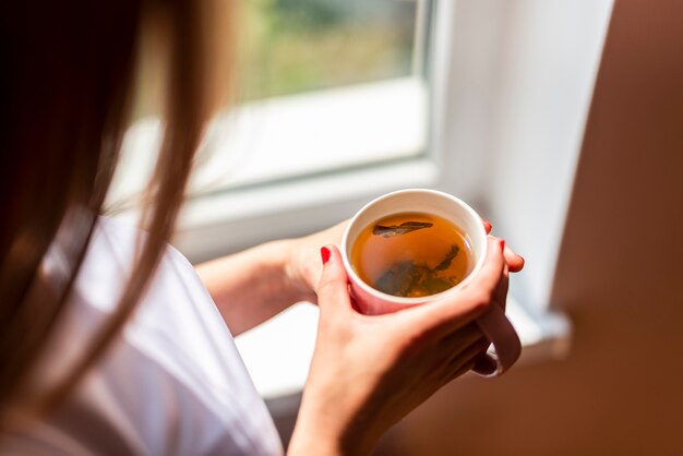 High angle woman holding hot tea