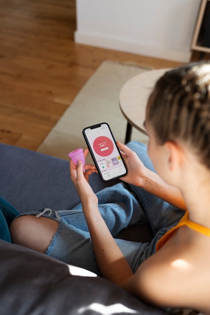 High angle woman holding menstrual cup