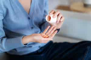 Free photo high angle woman holding pills