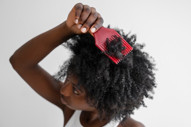 High angle woman holding pink comb