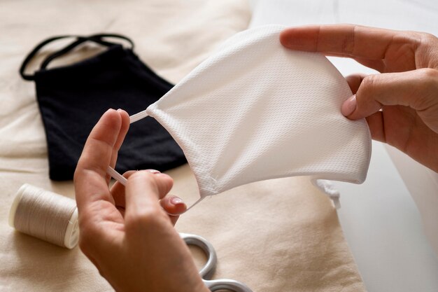 High angle of woman holding sewn face mask