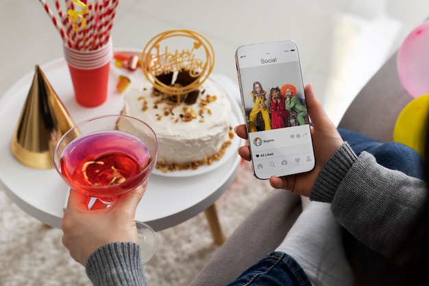 High angle woman holding smartphone and drink