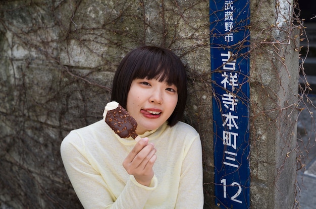 Free photo high angle woman holding tasty ice cream