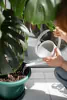 Free photo high angle woman holding watering can