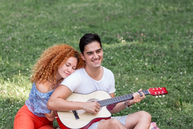 Free photo high angle of woman hugging her boyfriend in the park