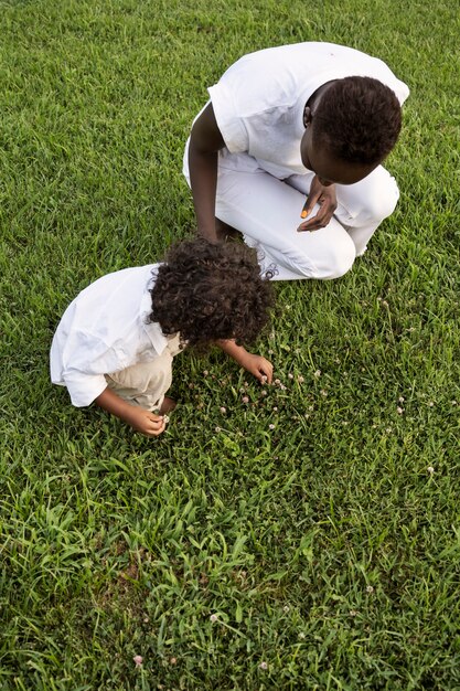 High angle woman and kid picking flowers