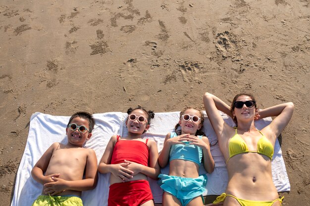 High angle woman and kids on beach