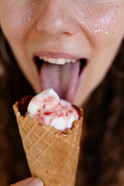 High angle woman licking ice cream cone