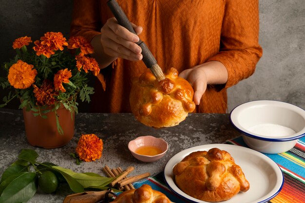 High angle of woman making pan de muerto