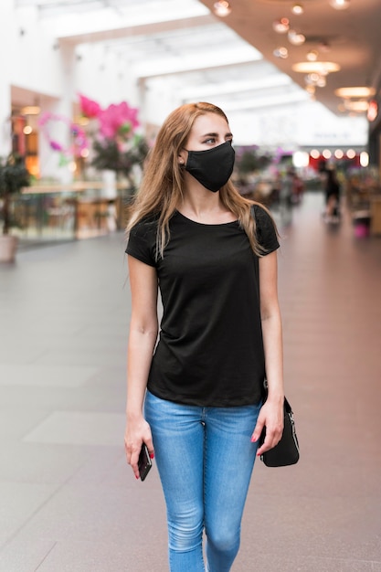 High angle woman at mall wearing mask