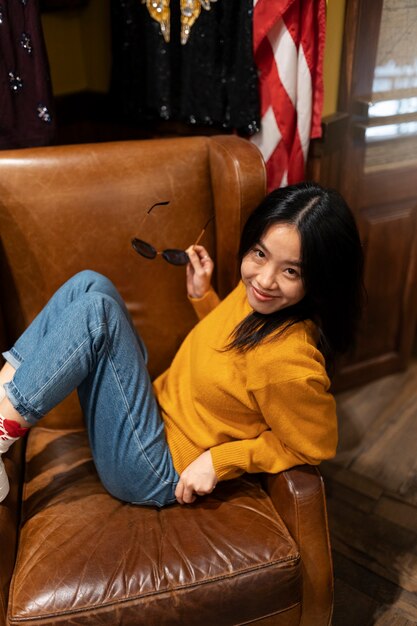 High angle woman posing on chair