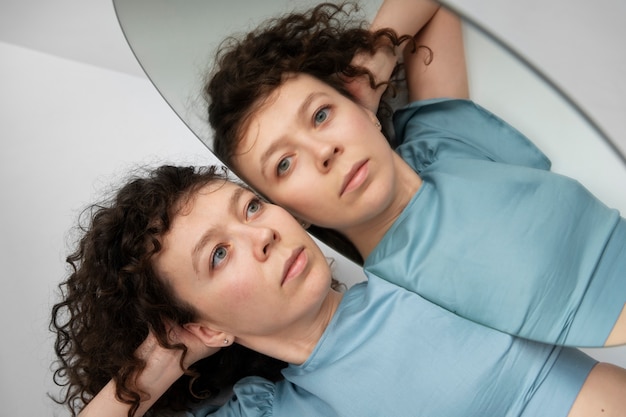 High angle woman posing near mirror