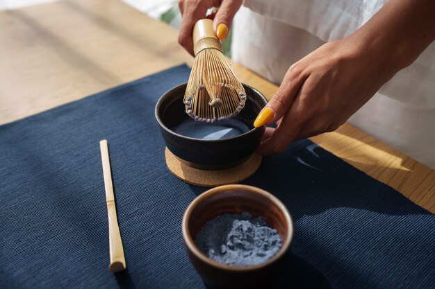 High angle woman preparing blue matcha at home